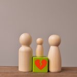 Wooden doll figures of family with break love heart. Concept of divorce