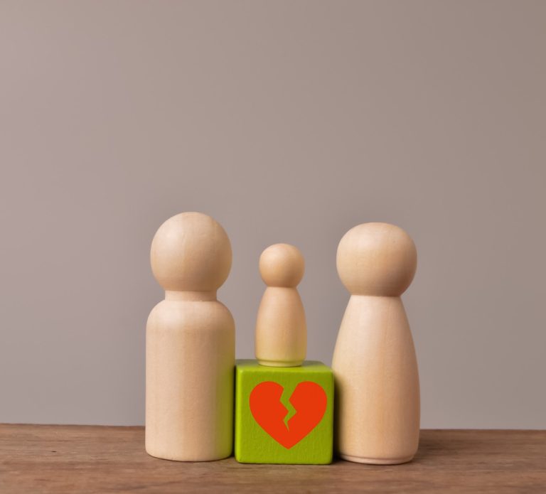 Wooden doll figures of family with break love heart. Concept of divorce